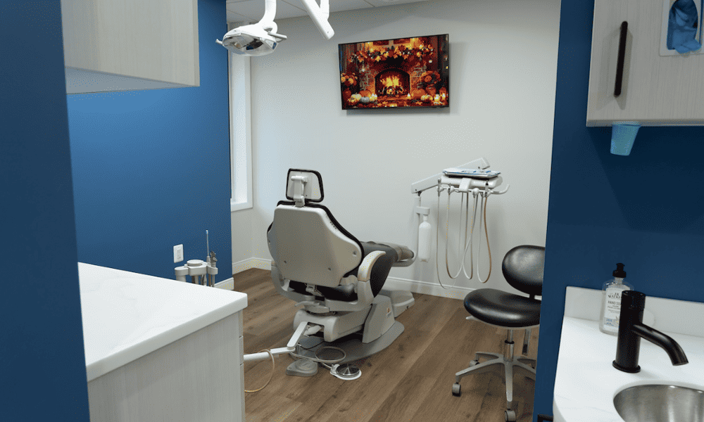 Dental operatory with patient chair, equipment and a wall screen