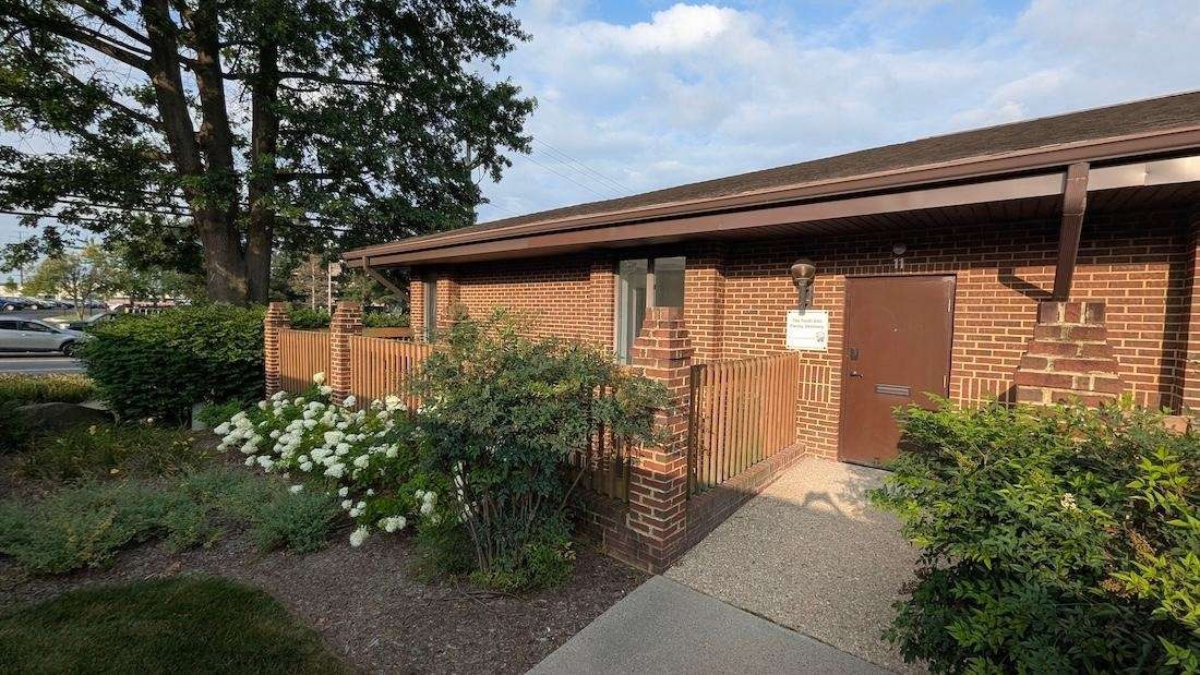 Brick exterior and walkway entrance of the Tooth Doc office