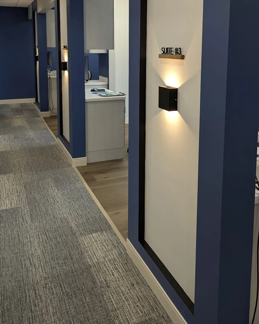 Hallway pillar marked Suite #3 with a glowing wall sconce